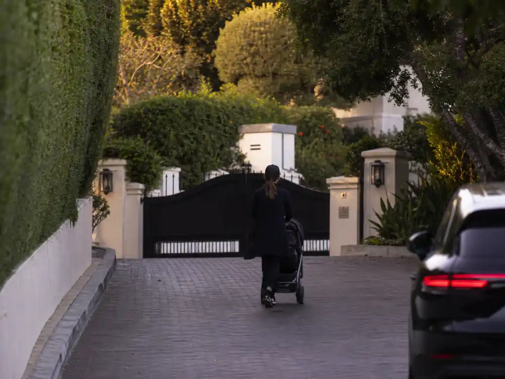 Gated home stroller silhouette for Kylie Jenner kids names and ages privacy era — face-forward newborn photos rarely posted