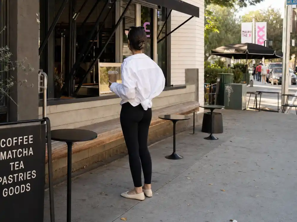 Oversized white shirt and leggings at Melrose coffee patio central to LA celebrity street style looks morning routines