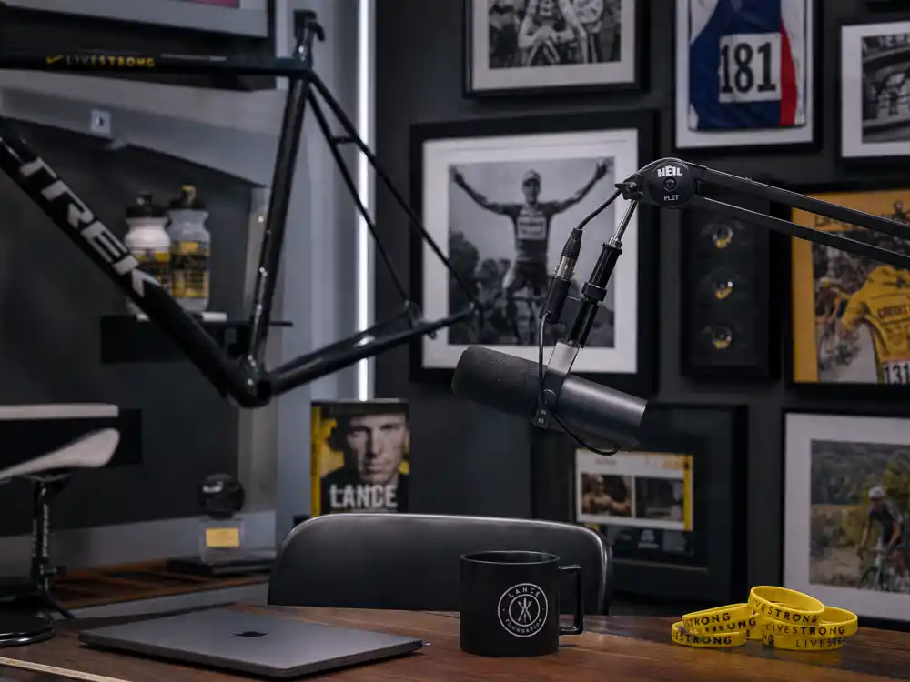 Podcast studio with cycling memorabilia for what happened to Lance Armstrong in 2026 media career