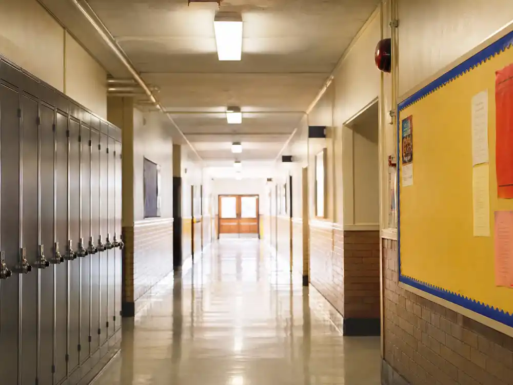 A sunny American high school hallway evoking Larisa Oleynik as Bianca in 10 Things I Hate About You