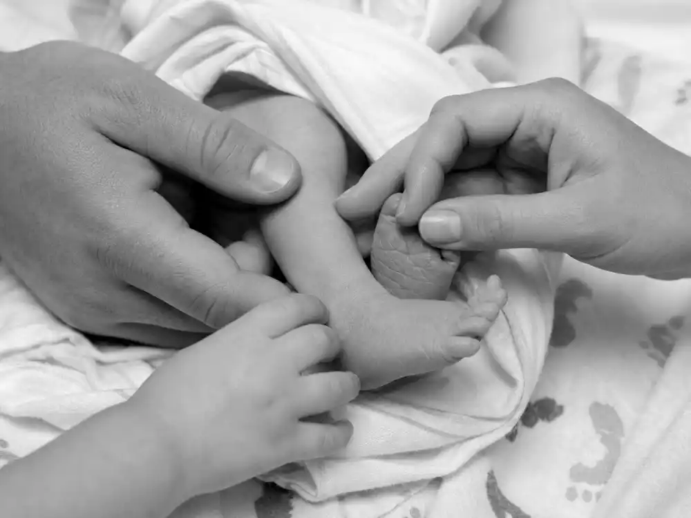 Family hands touching newborn leg for Lea Michele baby announcement second child birth — August 25 2024 Emery Sol Reich Instagram reveal