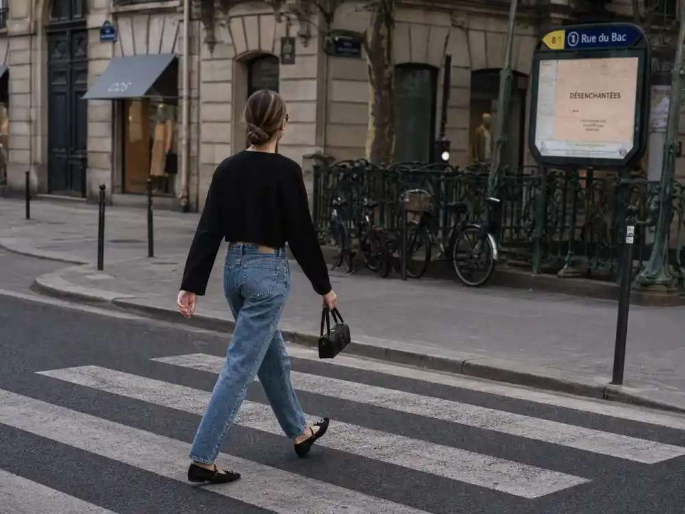 Vintage-wash straight jeans ballet flats and cropped cardigan illustrating Lily Collins Paris street style casual rotation
