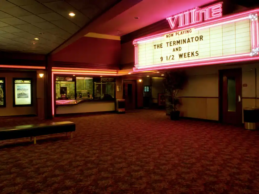 Empty 1980s movie theater lobby evoking Linda Hamilton early Hollywood and regional theater career beginnings