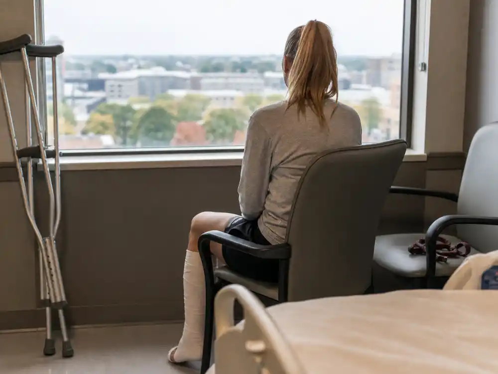 Hospital recovery room with crutches and dog leash for Lindsey Vonn baby announcement 2025 timeline — February 2026 Olympics crash recovery alongside pet companion Chance