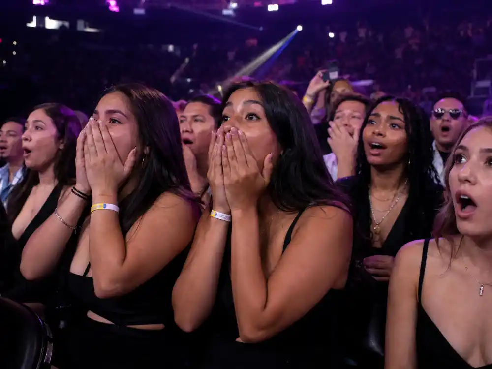 Shocked MTV VMA audience reactions frame the Madonna Britney Christina VMA kiss story when live television cameras captured gasps across Radio City Music Hall