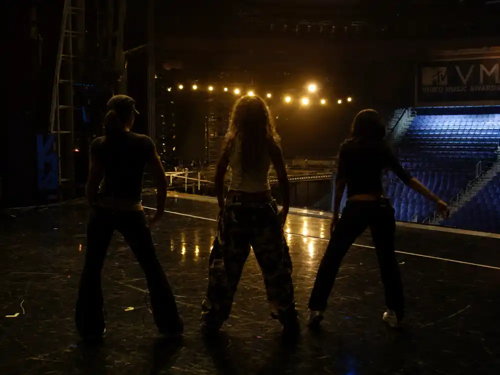 Backstage MTV VMA rehearsal silhouettes for Madonna Britney Christina VMA kiss story — three performers blocking choreography before the 2003 opening medley aired live