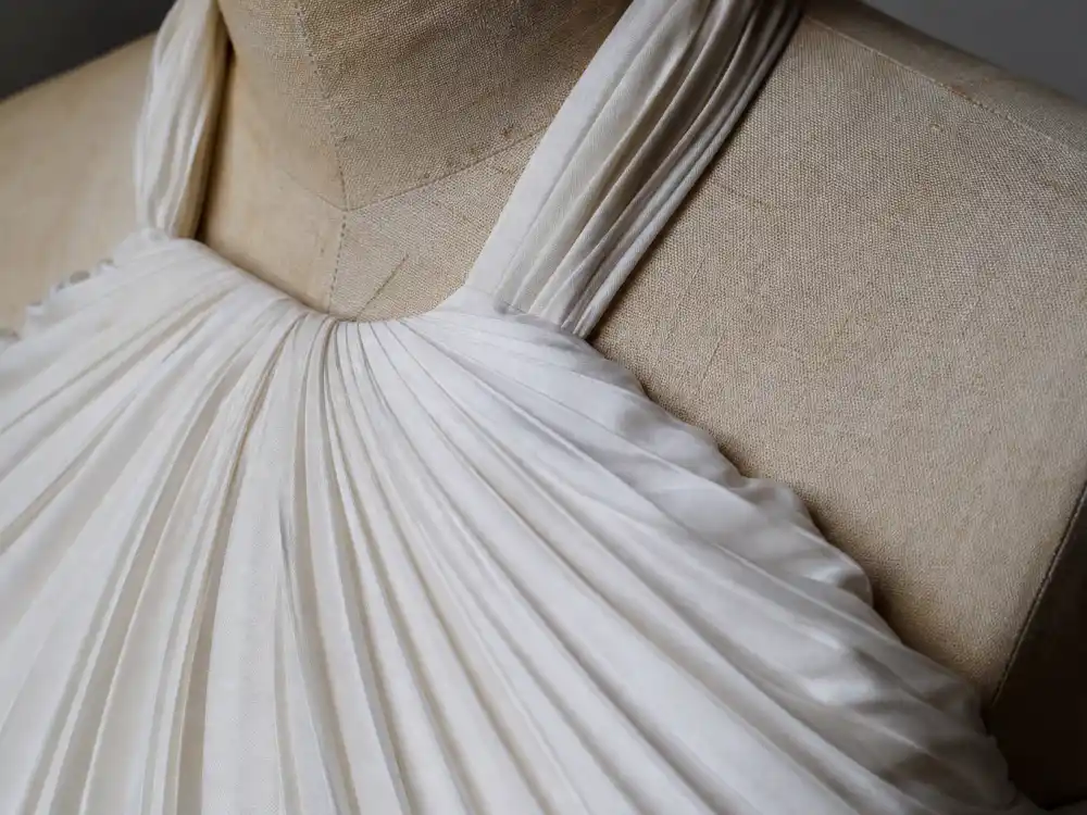 Sunray pleated white silk halter construction defining Marilyn Monroe white dress history costume design by William Travilla