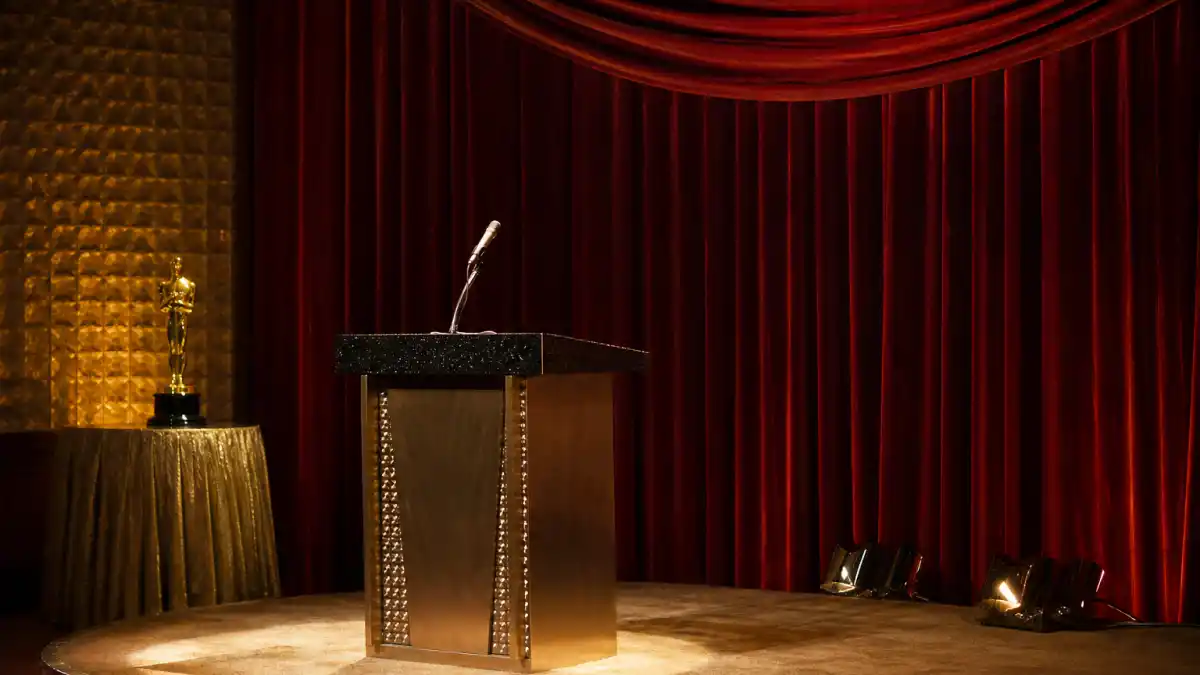 Marlon Brando declined Oscar — vintage 1970s awards theatre stage with empty podium, microphone, and generic golden statuette silhouette
