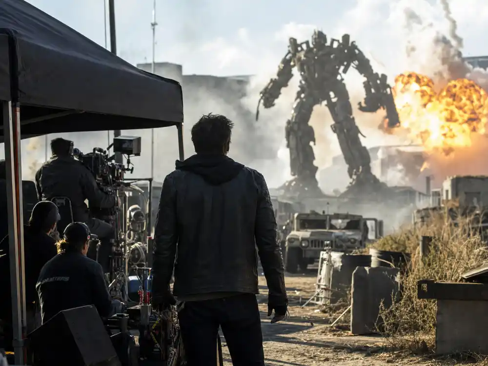 Blockbuster action movie set with robot props representing the Megan Fox career peak during the Transformers franchise era