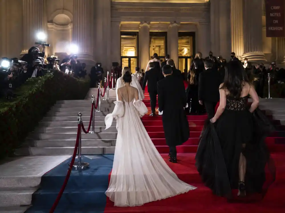 Anonymous guests ascending Metropolitan Museum steps on the Met Gala 2026 guest list red carpet May 4