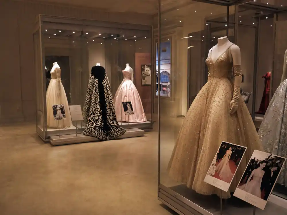 Costume Institute gallery with iconic formal evening gowns on mannequins illustrating Met Gala best dressed all time archive history and museum exhibition context