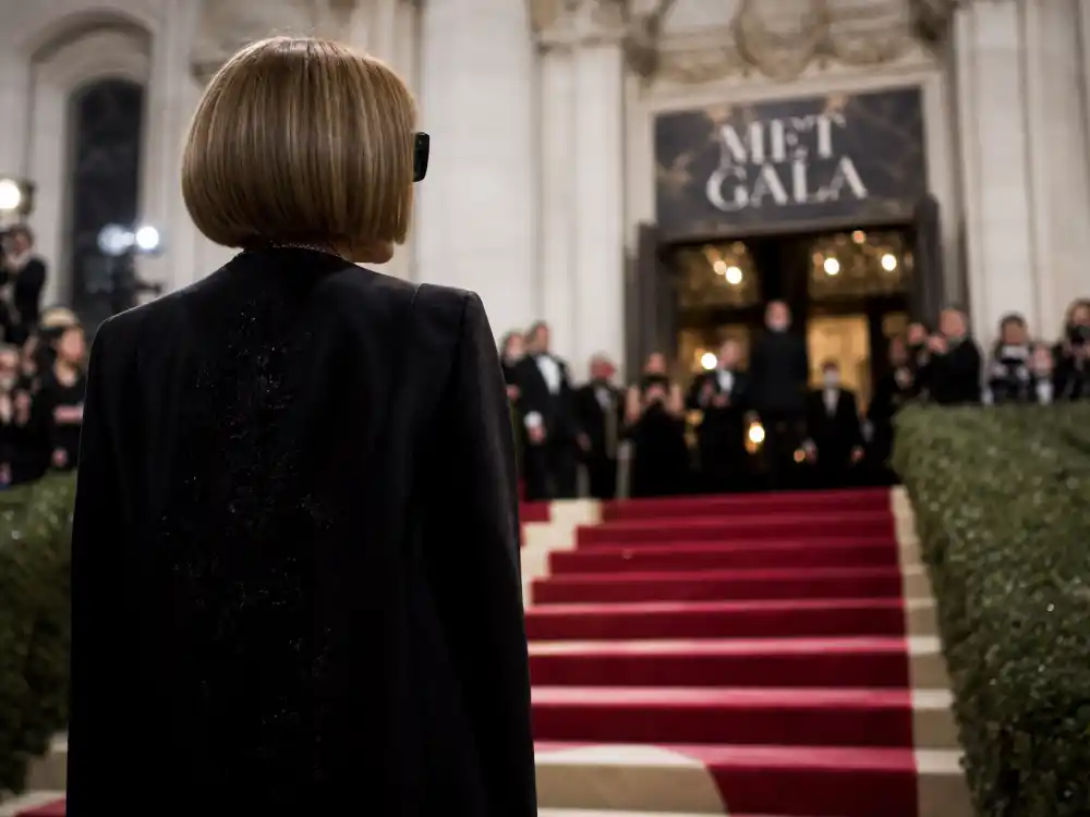 Anna Wintour silhouette at the museum gala entrance — three decades shaping Met Gala themes by year complete list curation