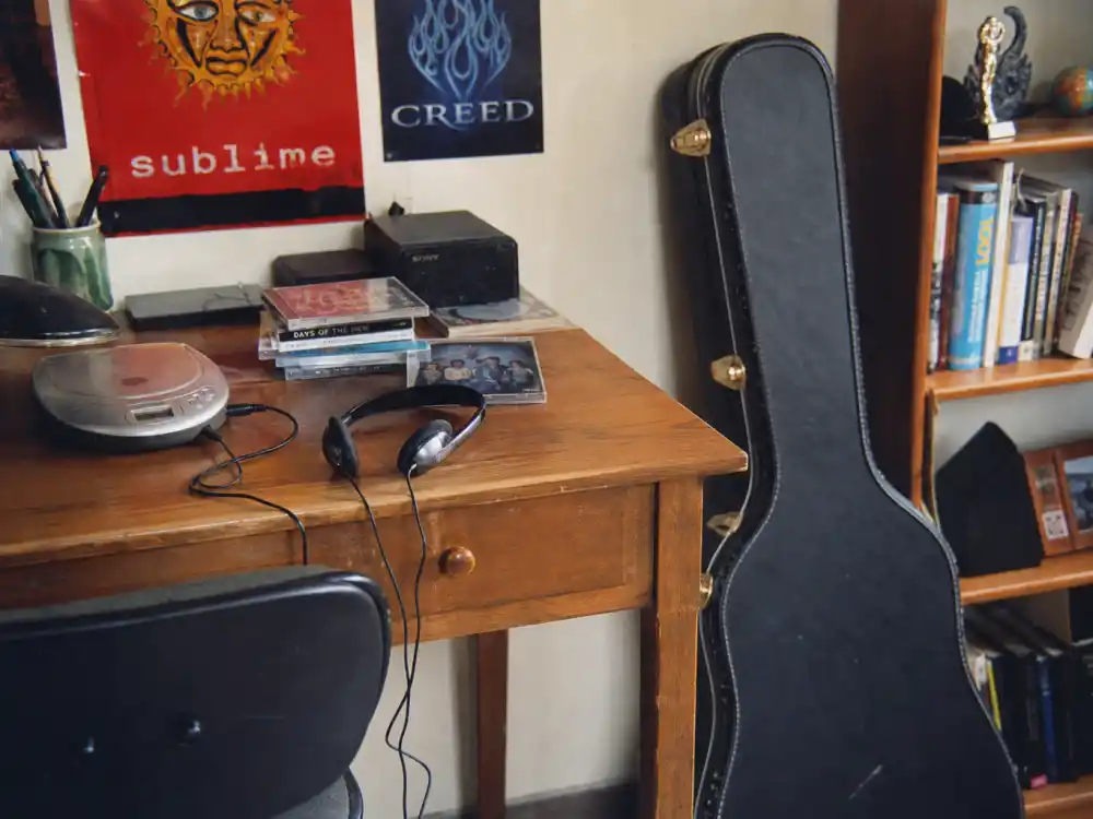 A 2001 teen bedroom with CD player and acoustic guitar evoking what happened to Michelle Branch at her Everywhere breakthrough