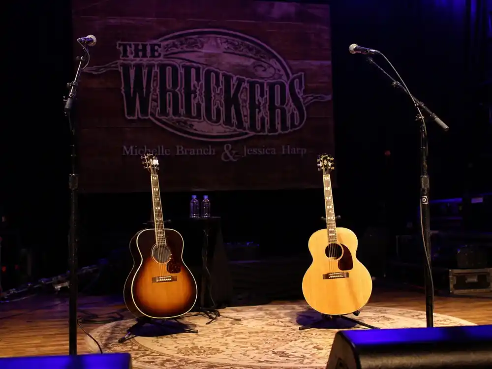 Nashville-style country stage with two microphones for what happened to Michelle Branch in The Wreckers duo era