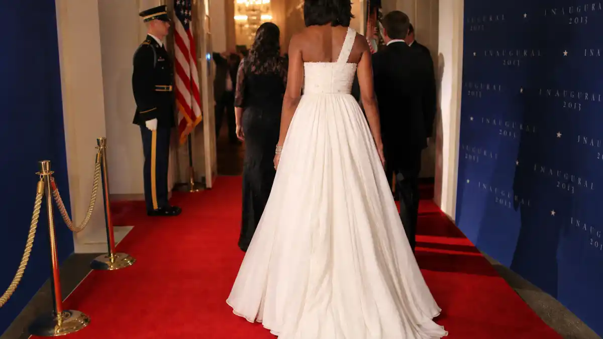Michelle Obama Jason Wu inaugural gown — white one-shoulder chiffon dress on couture dress form in fashion atelier with flowing ivory train