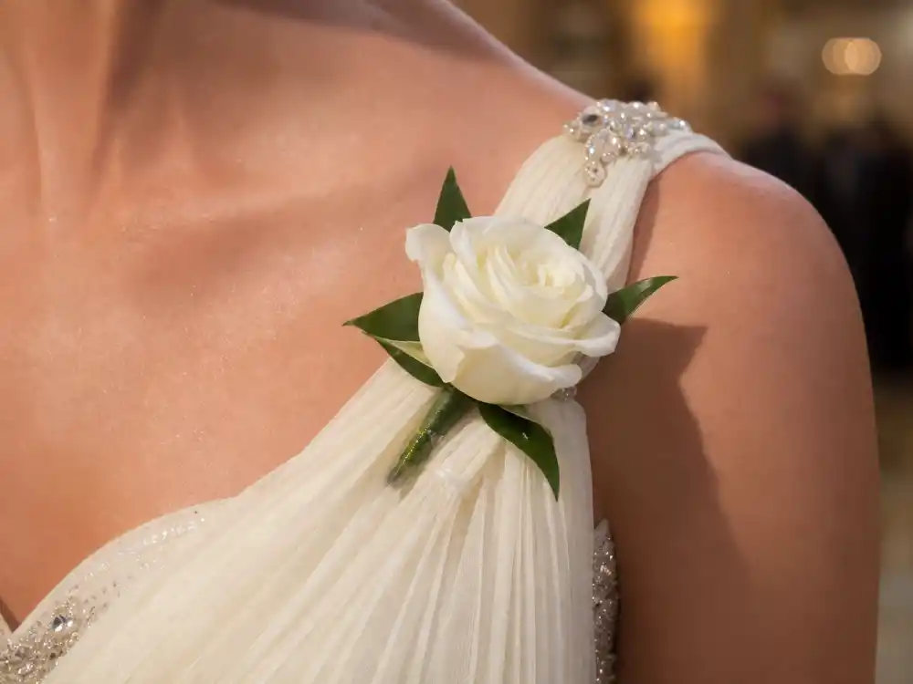 White rose corsage pinned to ivory chiffon strap accessory paired with the Michelle Obama Jason Wu inaugural gown one-shoulder silhouette