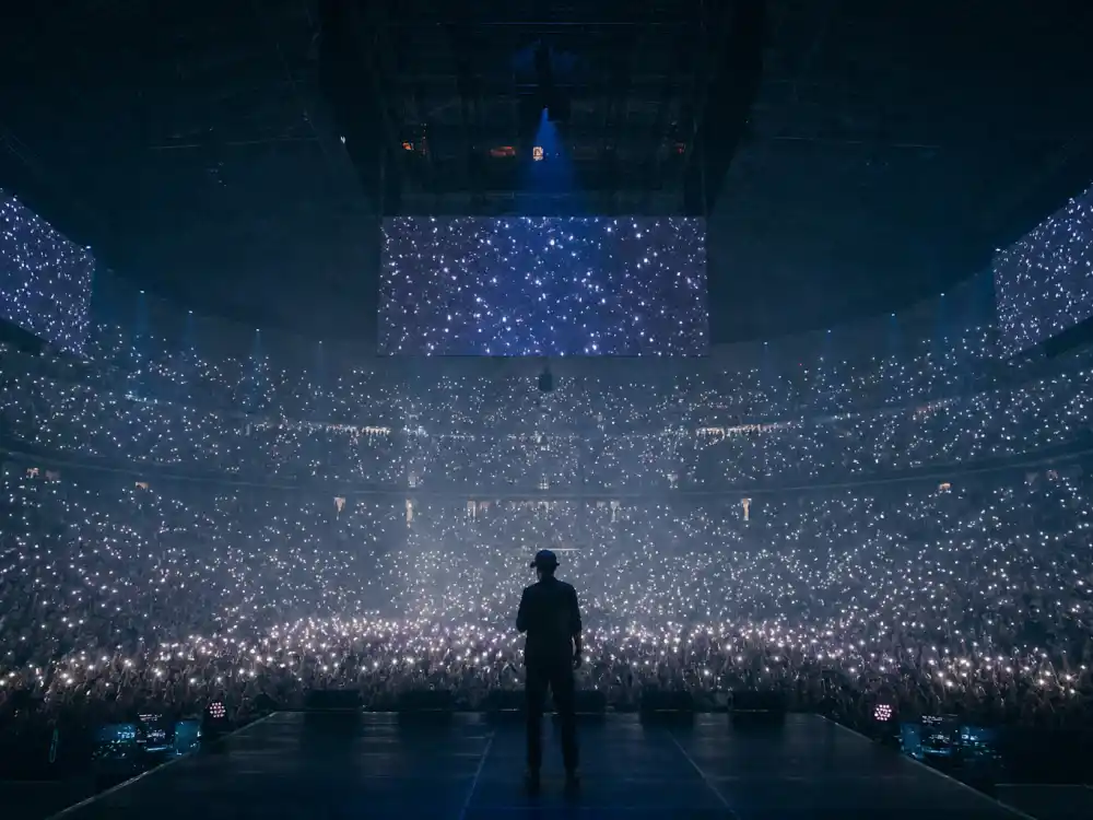 Arena tour silhouette from behind for Miley Cyrus Billy Ray Cyrus fame story global chart dominance editorial without identifiable faces