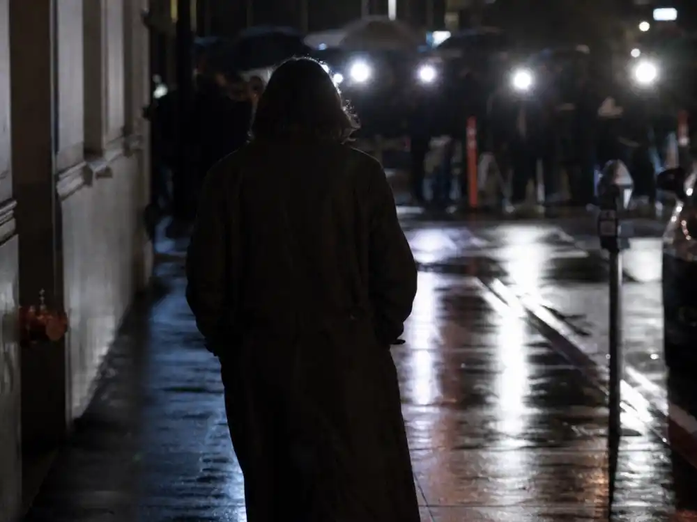 Rain-slicked Hollywood sidewalk with paparazzi flashes, symbolizing what happened to Mischa Barton during her public struggles