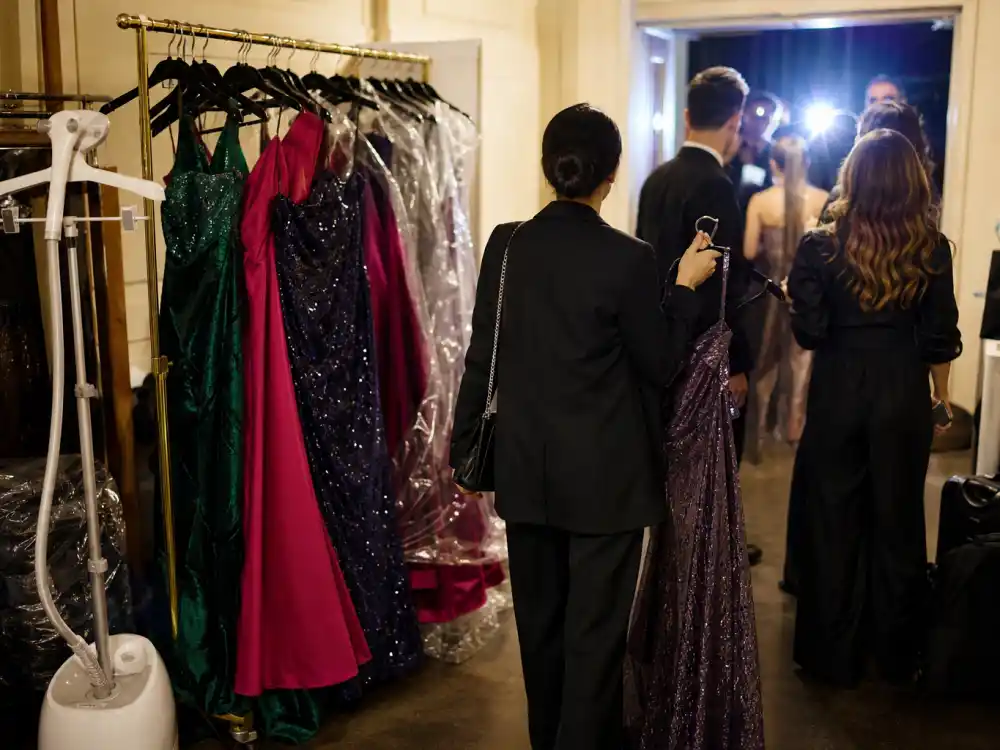 Red carpet backstage garment rack with premiere gowns showing how Molly Dickson celebrity stylist clients prepare for awards season telephoto moments