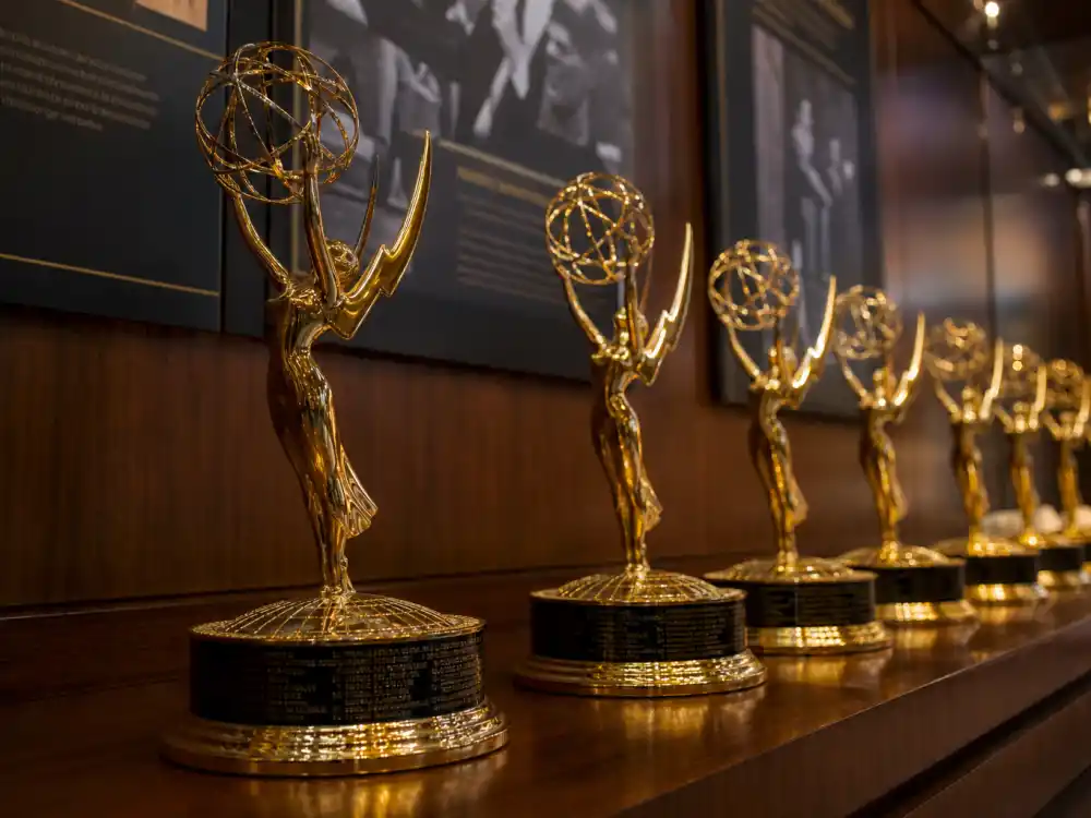 Emmy winged statuettes on awards shelf for most awarded celebrities of all time television acting records