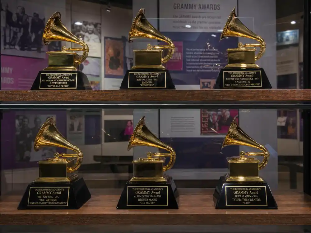 Grammy gramophone trophies on museum display shelf ranking most awarded celebrities of all time music winners