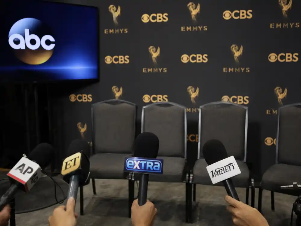 Backstage press room microphones cluster where most awkward award show interviews unfold after winners leave the main stage