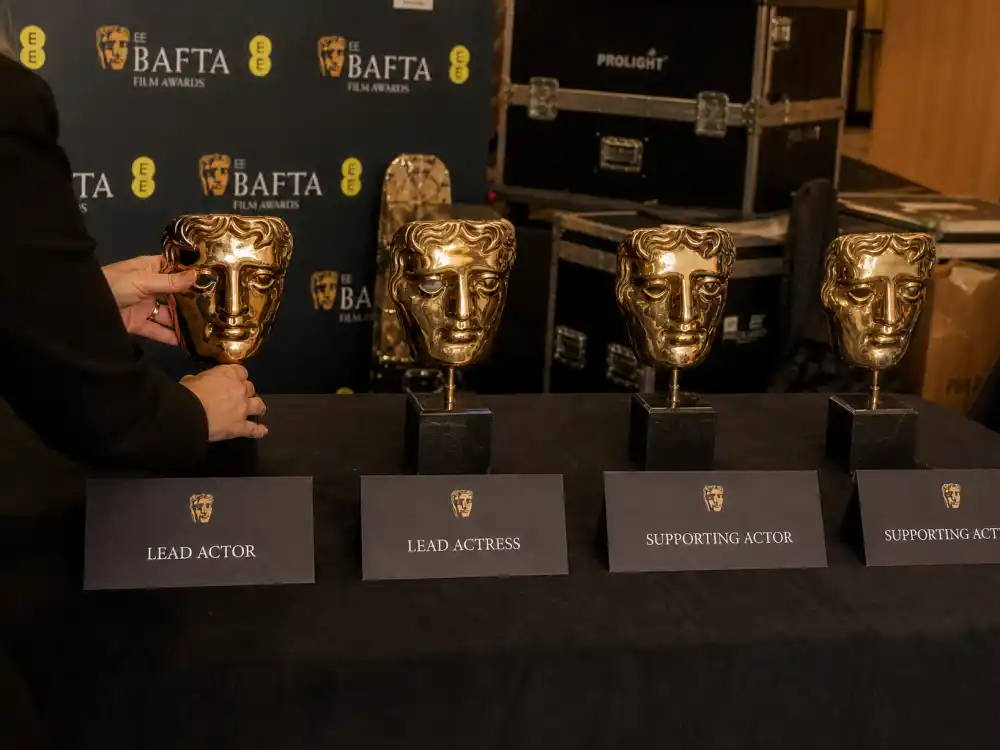 Lead and supporting BAFTA category placards beside mask trophies for most BAFTAs won by an actor breakdown