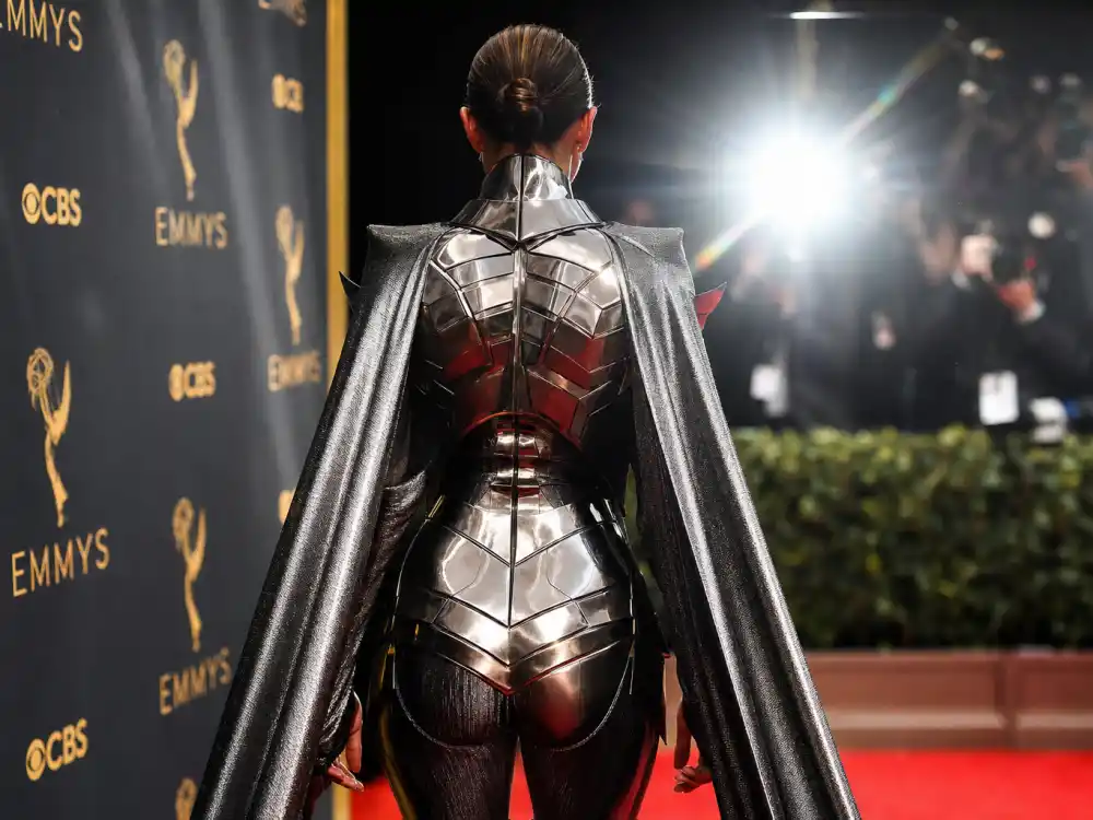 Futuristic metallic armor bodysuit with cape evoking Lil Nas X Versace spectacle in most daring award show outfits ever menswear history
