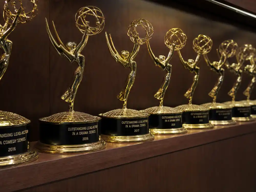 Shelf of generic golden television award statuettes illustrating the most Emmys won by an actor all-time acting leaderboard