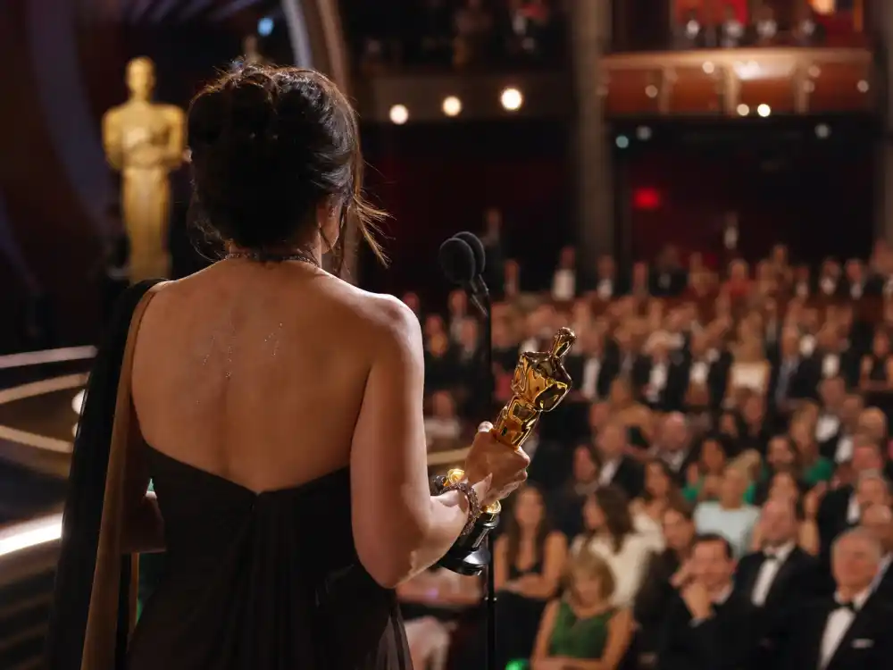 Emotional Oscar acceptance speech silhouette at podium microphone — among the most memorable acceptance speeches ever since Halle Berry won Best Actress in 2002