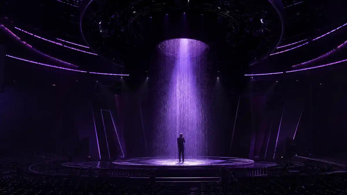 Most memorable Grammy performances — silhouetted artist under purple rain spotlight on a massive awards arena stage during a legendary televised set