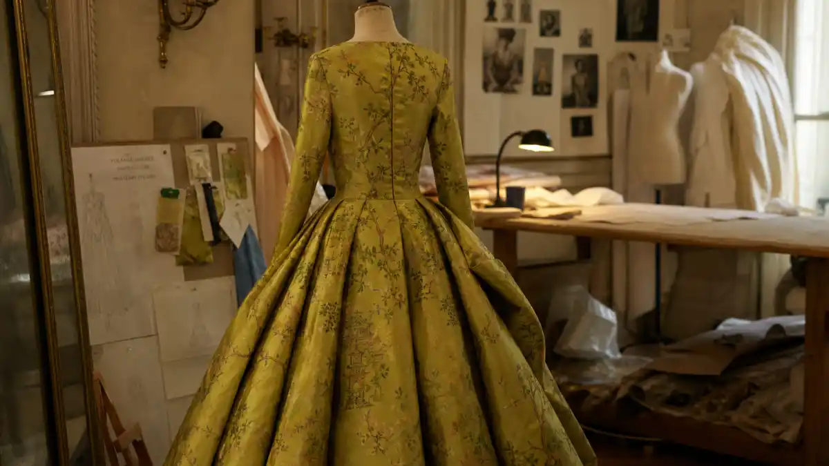 Nicole Kidman chartreuse David Bowie dress history — chartreuse silk chinoiserie Dior gown on couture dress form photographed from behind in Paris atelier