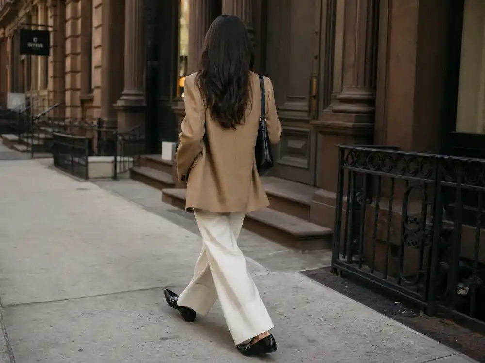 Ivory wide-leg trousers and black pointed loafers rotation within NYC celebrity street style trends column silhouette dressing