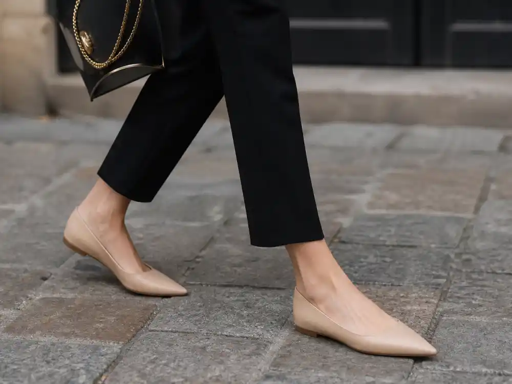 Pointed toe nude flats with cropped trousers illustrating Olivia Palermo street style guide footwear discipline