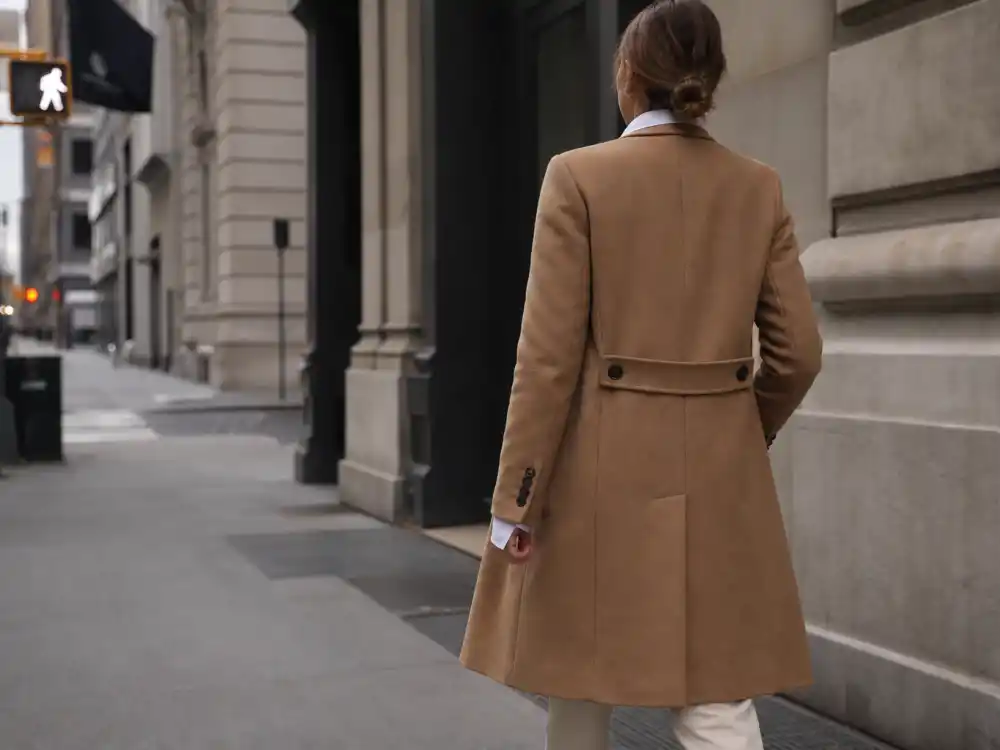 Tailored camel wool coat over crisp shirt central to Olivia Palermo street style guide outerwear codes