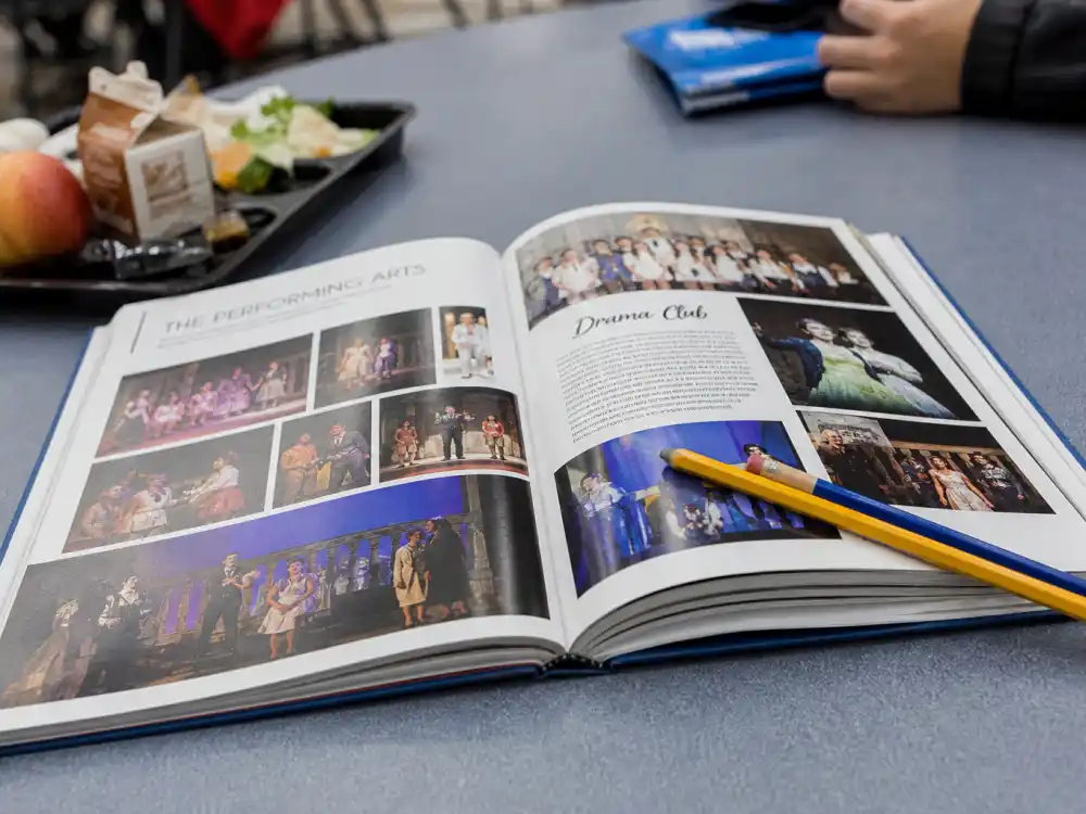 High school yearbook on cafeteria table reflecting Olivia Rodrigo age and birthday 2026 teen years before Disney series and breakout pop stardom