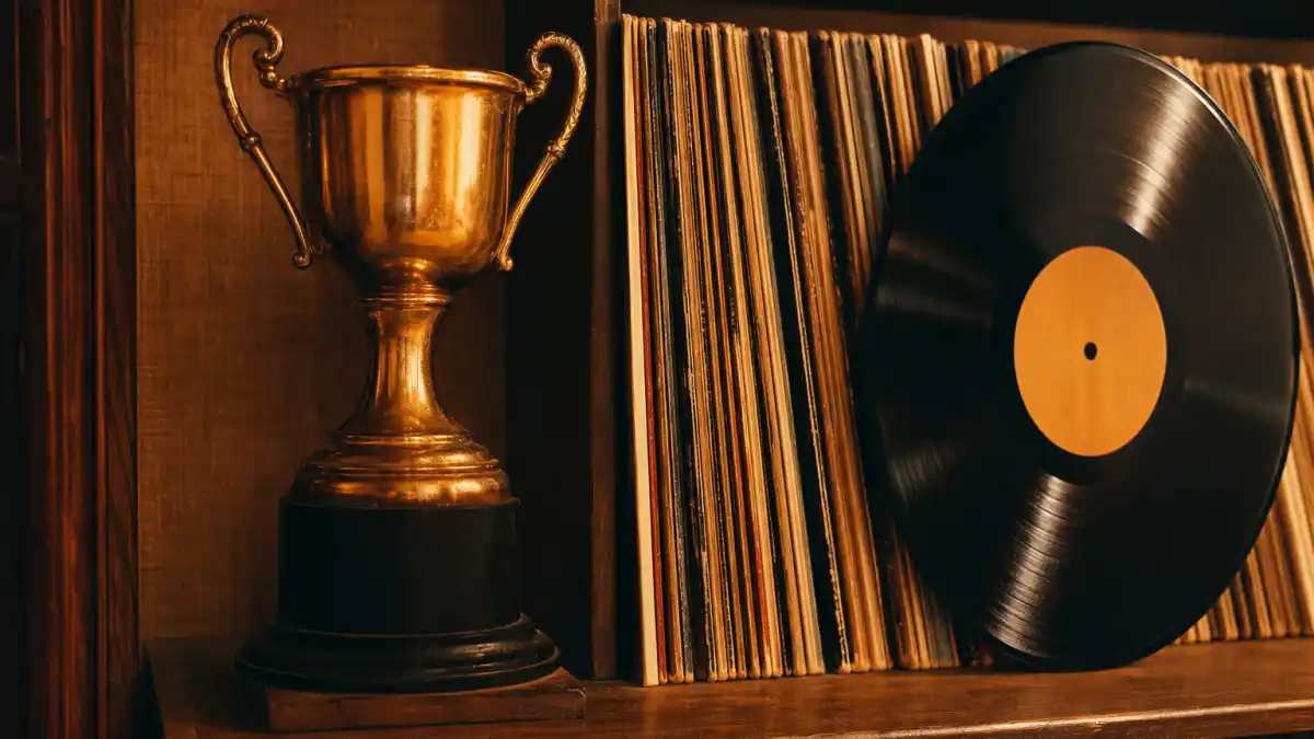 One hit wonders who won Grammys — vintage vinyl records beside a generic golden music trophy under warm studio light