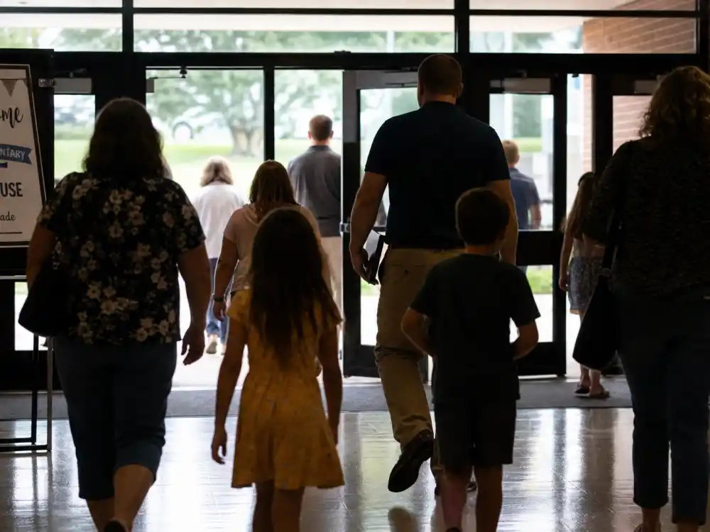 School auditorium from behind for Orlando Bloom Katy Perry Miranda Kerr co-parenting joint attendance privacy editorial without identifiable faces