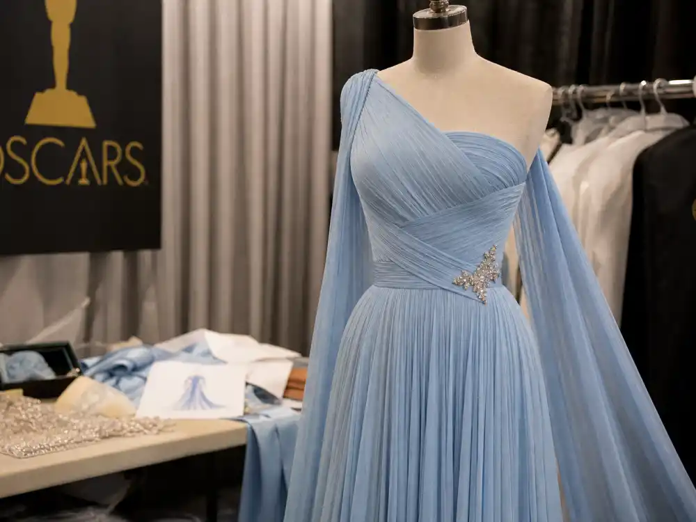 Powder-blue pleated Oscar evening gown evoking Lupita Nyong'o 2014 Prada look in Oscar red carpet best dressed all time rankings