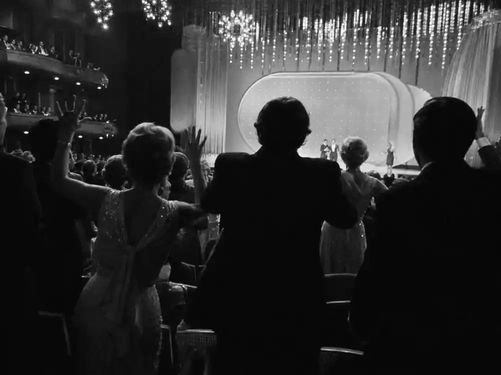 Shocked audience silhouettes reacting during the Oscars streaker 1974 moment as live broadcast cameras captured the historic disruption