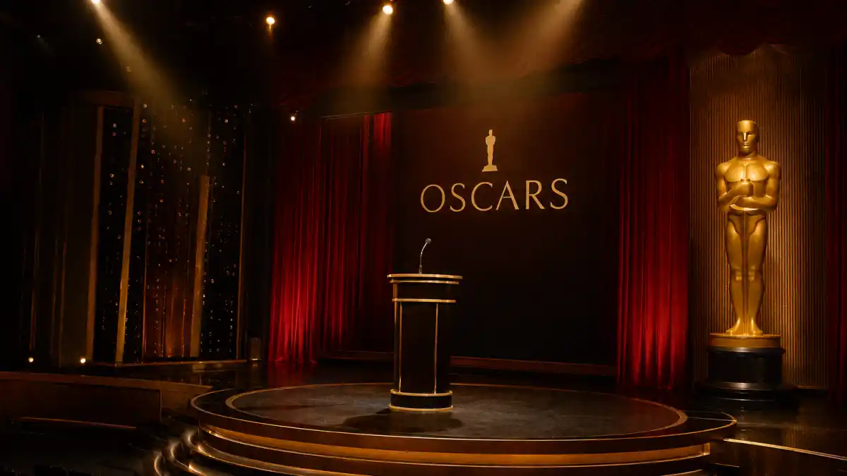 Oscars streaker 1974 — vintage 1970s awards ceremony stage with red curtains and golden spotlight at the Dorothy Chandler Pavilion