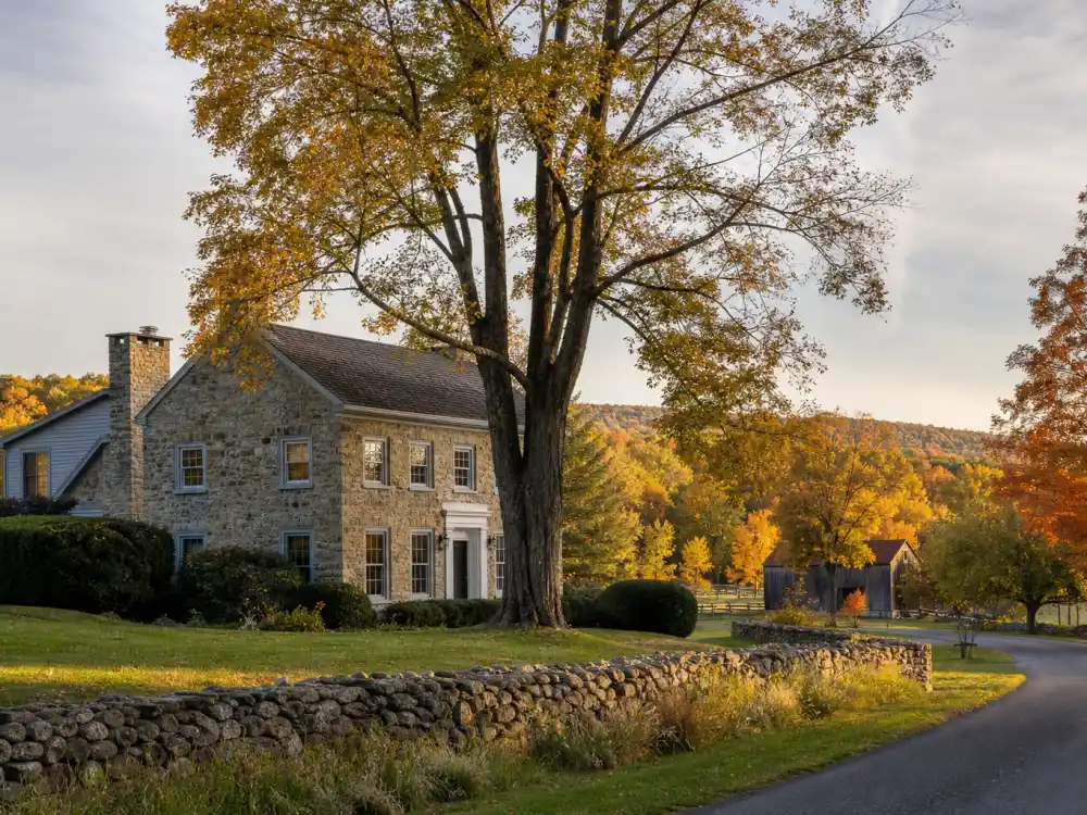 Upstate New York stone farmhouse at golden hour for where is Paulina Porizkova now in 2026 Bedford life