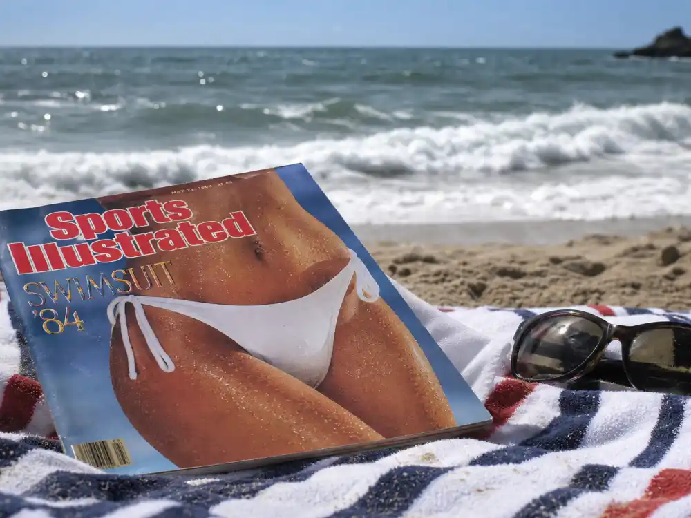 Vintage Sports Illustrated swimsuit magazine on beach for where is Paulina Porizkova now SI cover breakthrough
