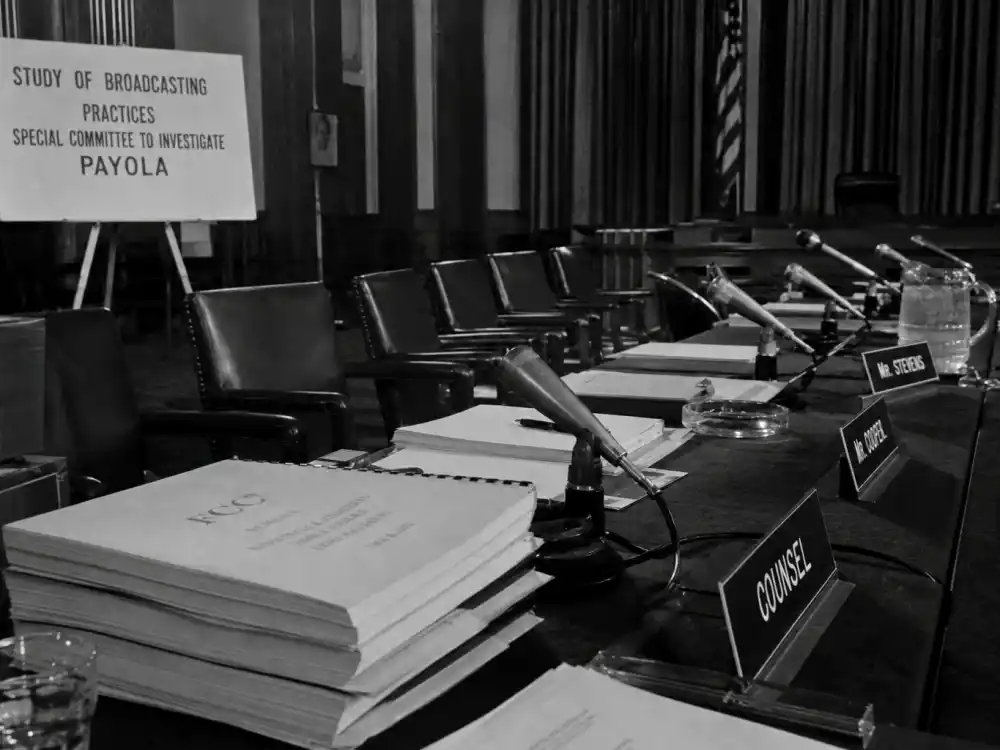 Congressional hearing room with FCC documents on payola and Grammy voting controversies — 1960 inquiry that reshaped radio promotion rules