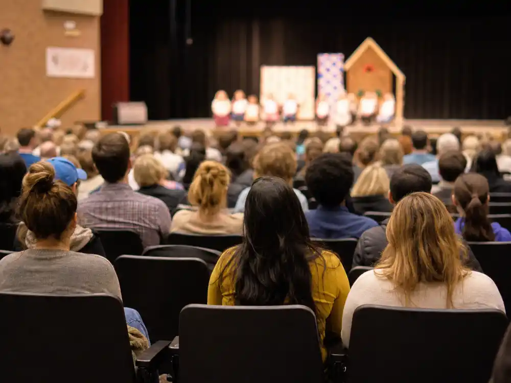 School event auditorium from behind for Pete Davidson Kim Kardashian co-parenting North joint attendance editorial without identifiable faces