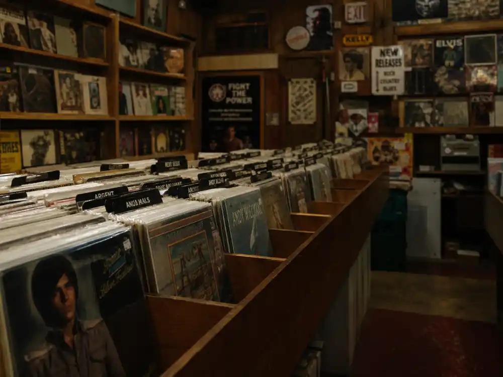 Vinyl record store interior reflecting Post Malone age and birthday 2026 genre-blending catalog spanning hip-hop, pop, rock, and country crossover releases