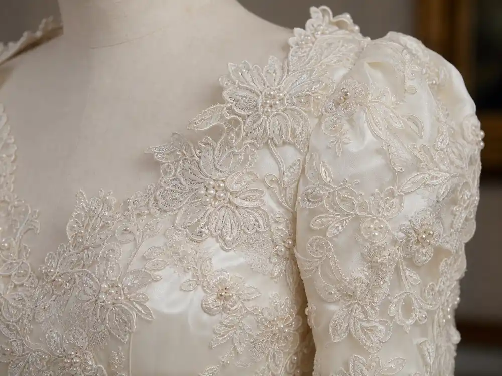 Antique Carrickmacross lace appliqué with pearl beading central to Princess Diana wedding dress history couture construction