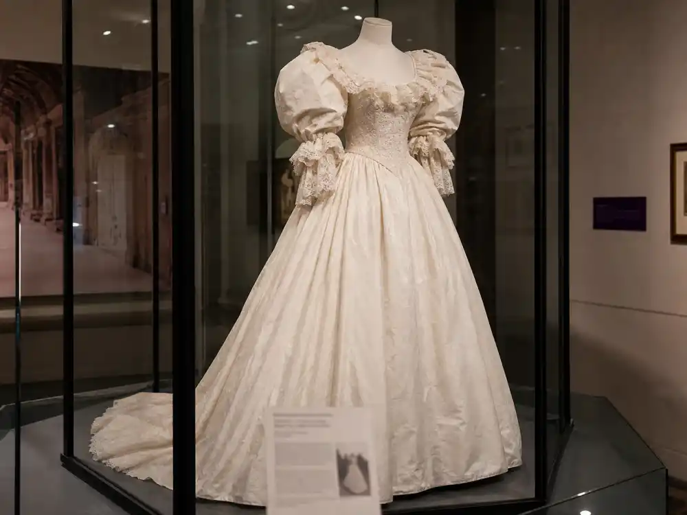 Fashion museum vitrine preserving Princess Diana wedding dress history as the most influential royal bridal gown of the 1980s