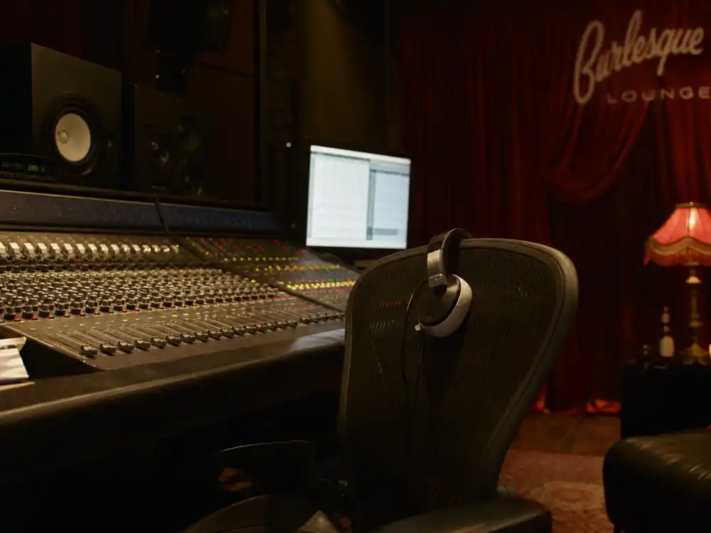 Early 2000s recording studio with red velvet curtain evoking the Pussycat Dolls Dont Cha and Buttons chart peak