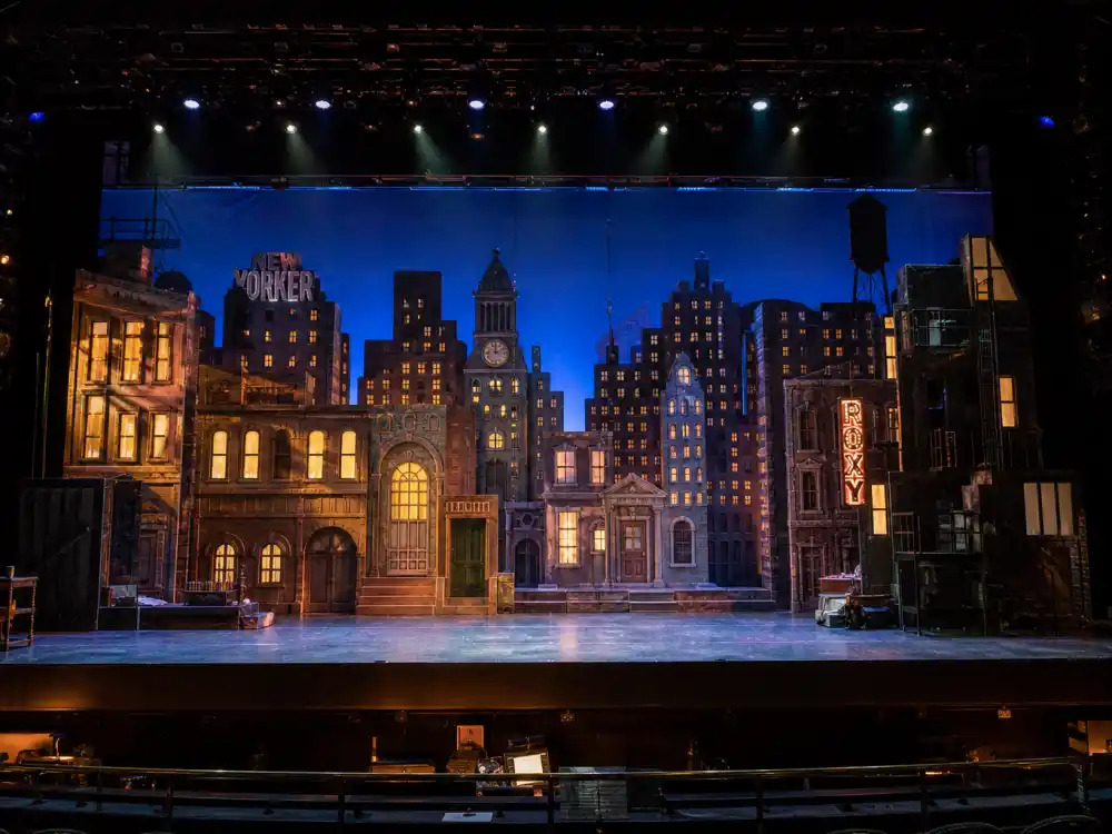 A colorful musical theater stage evoking Quvenzhané Wallis title role in the 2014 Annie remake